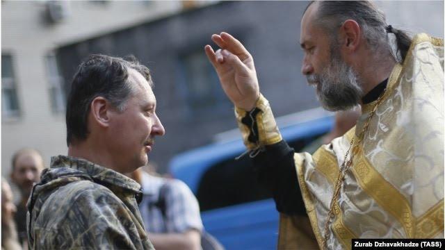 A priest blesses Russian Colonel Igor Girkin (Strelkov)
